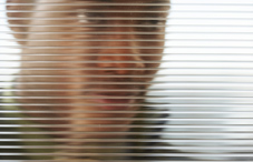 Man looking through blinds Man looking through blinds