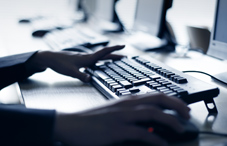 One hand on computer mouse and the other on keyboard One hand on computer mouse and the other on keyboard