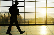 Man walking through building with sun beaming Man walking through building with sun beaming