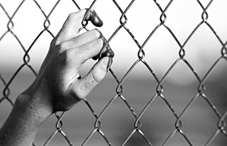 A hand grabbing a gate A hand grabbing a gate