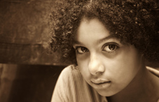 Young girl with curly hair has expressionless face