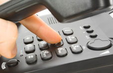 Someone dialing a telephone