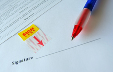 A "sign here" signature line 