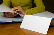 Woman looking through binder Woman looking through binder