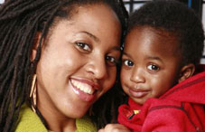Mother smiling and holding baby Mother smiling and holding baby