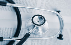 Stethoscope laying on a document Stethoscope laying on a document