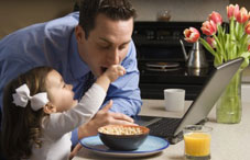 Daughter feeding father cereal Daughter feeding father cereal