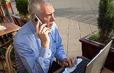 Man on cell phone and laptop Man on cell phone and laptop