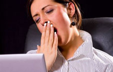 Woman with hand over mouth yawning Woman with hand over mouth yawning