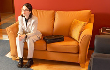 Woman sitting on orange couch