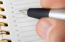 Writing information in a day planner Writing information in a day planner