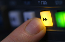 Someone pressing the fast forward button Someone pressing the fast forward button