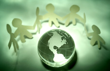 People icons standing around a globe People icons standing around a globe