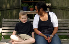 Woman and boy sitting on bench Woman and boy sitting on bench