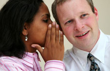 Woman whispering to a man