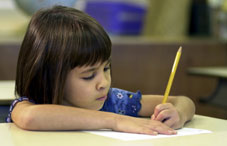 Young girl erasing her paper