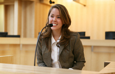 Woman speaking into a microphone