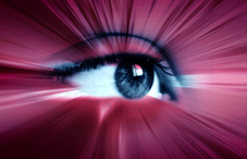 Pink light rays coming from an eye