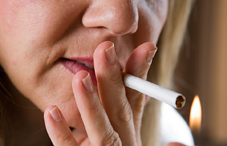 Closeup of woman lighting cigarette