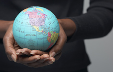 Woman's hands holding small globe Woman's hands holding small globe