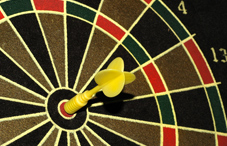 Dart in bullseye of dartboard Dart in bullseye of dartboard