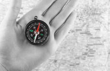 Hand holding compass