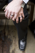 Men's hands entwined with wedding rings