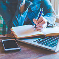 photo of red pencil standing out against black pencils