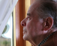 Man looking out window