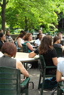 people sitting outside around tables people sitting outside around tables