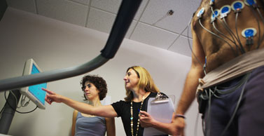 Dr. Tate and a nutritionist conduct a stress test on a study participant.