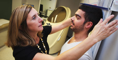 Dr. Tate measures the height of a study participant.