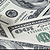 Stethoscope on top of one hundred dollar bills