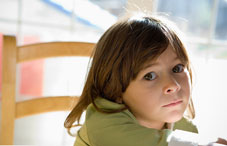 Girl sitting with a blank expression