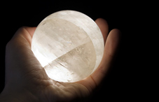 Hand holding a glowing ball