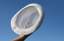 Holding a hat in the air