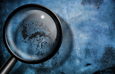 Magnifying glass looking at fingerprint