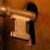 A hand sticking a key in a lock