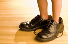 Child's feet in grownup shoes