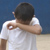 Boy rubbing his eyes with forearm