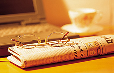 Eye glasses on top of a newspaper