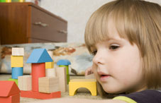 Young girl play toy shapes