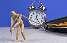 Wooden doll pulling a clock and folder