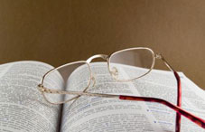 Eye glasses laying on an open book
