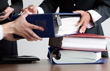 Someone being handed binders