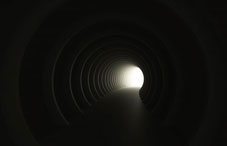 Curving tunnell with light at the end 