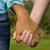 Two people holding hands