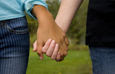 Two people holding hands