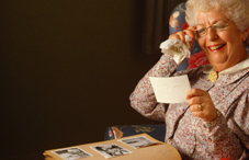 Elderly woman laughing at picture