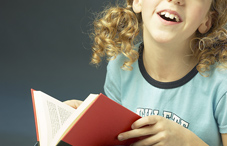 Girl smiling with book in hand